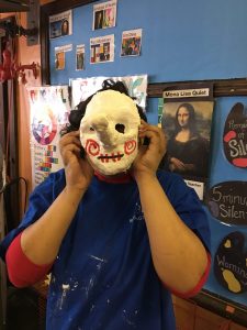 8th graders trying on their masks